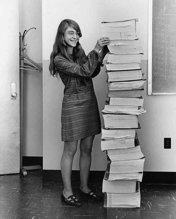  Margaret Hamilton shown in 1969 standing beside listings of the software developed by her and her team for the Apollo program's Lunar Module and Command Module.